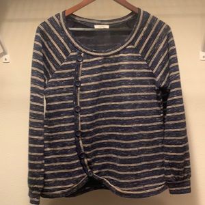 A long sleeve side buttoned top from the brand Maurices. It is a size Medium.